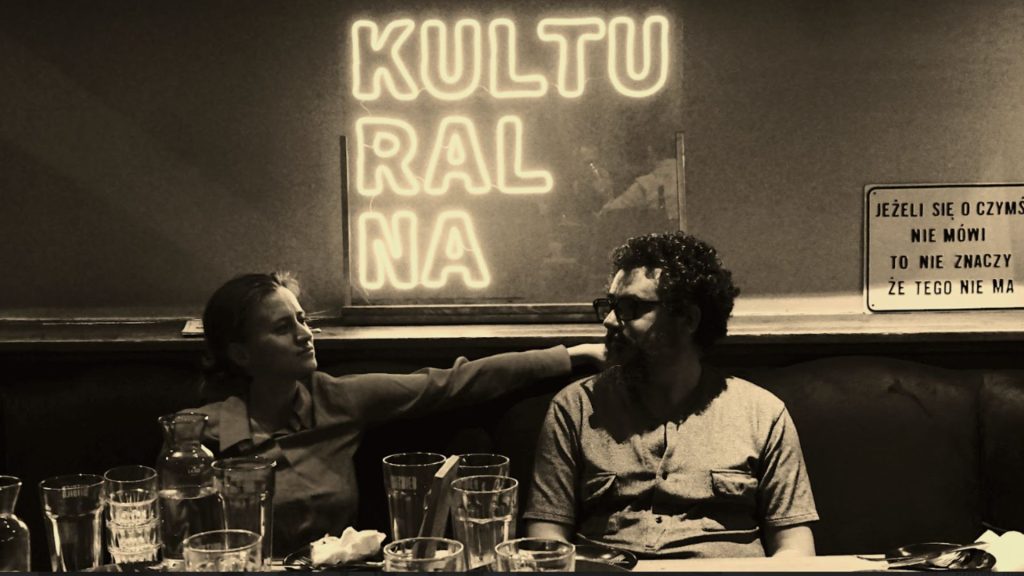 Arnaud Sauli and Ania Szczepanska at the Kulturalna bar (Warsaw). The phrase in Polish hanging on the wall on the right means: "Just because we don't talk about it doesn't mean it doesn't exist"